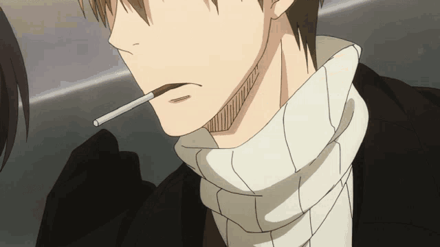 a man with a scarf around his neck smoking a cigarette