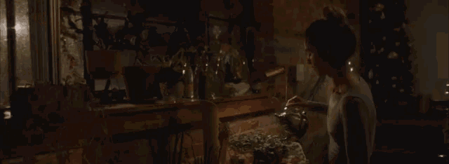 a person watering a potted plant with a tea kettle