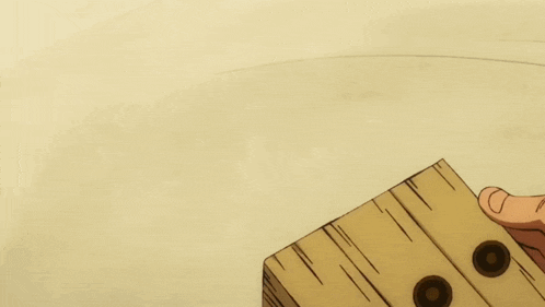 a person holding a piece of wood with three holes in it
