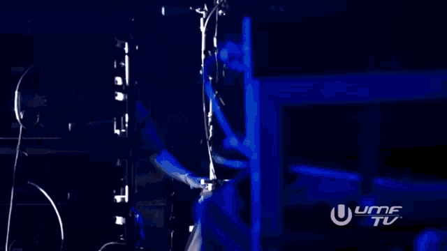 a man in a black shirt stands in front of a screen that says ultra tv