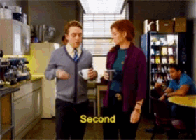 a man and a woman are standing in a kitchen with the word second on the bottom right