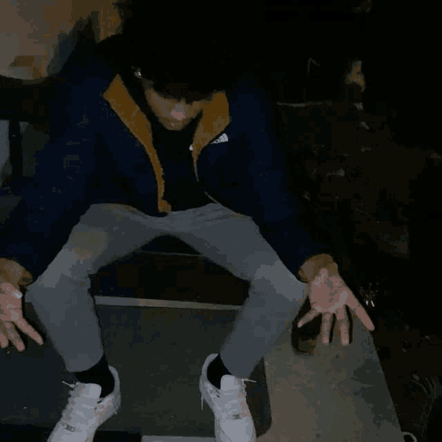 a man wearing a north face jacket is sitting down