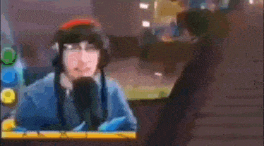 a man wearing headphones is talking into a microphone .
