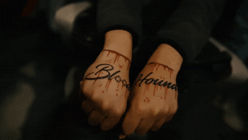 a person has a tattoo on their hands that reads bloodhound