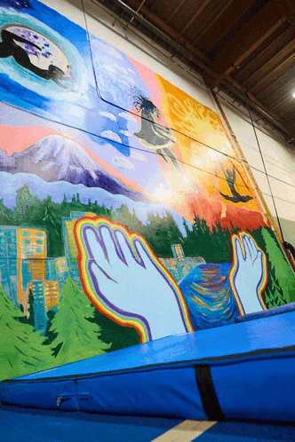 a large mural on a wall with a blue mat in front