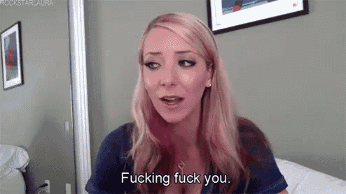 a woman with pink hair is saying fucking fuck you .