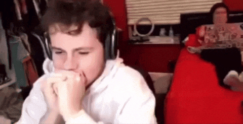 a man wearing headphones is sitting in front of a computer screen in a room .