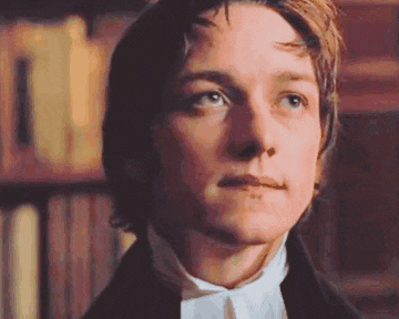 a close up of a man 's face in a library