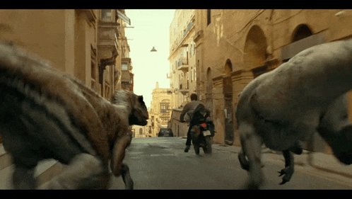 a man riding a motorcycle is being attacked by a group of monsters