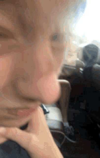 a close up of a person making a funny face while sitting in a chair .