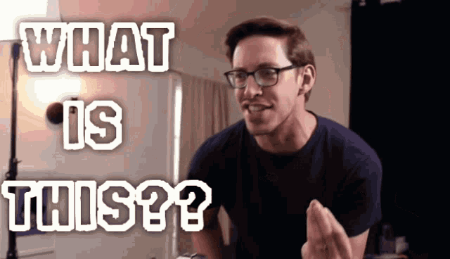 a man wearing glasses and a blue shirt says what is this