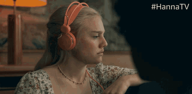 a woman wearing headphones with the hashtag #hannatv at the bottom