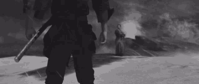 a black and white photo of a samurai with a sword