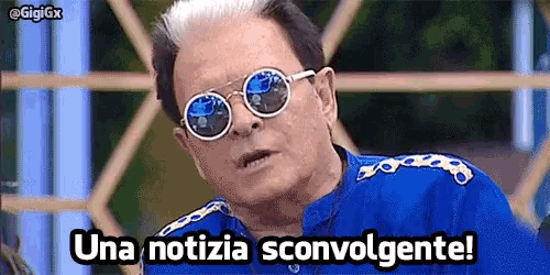 a man wearing sunglasses and a blue shirt says una notizia scovolgente