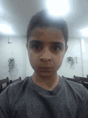 a young man taking a picture of himself in a dark room