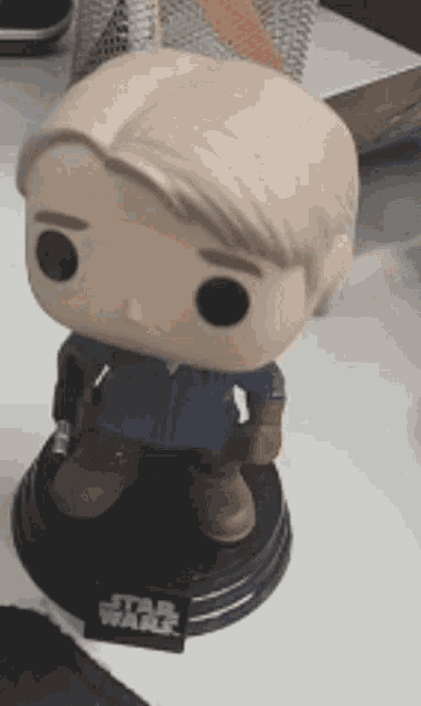 a funko pop figure of han solo from star wars is sitting on a table .