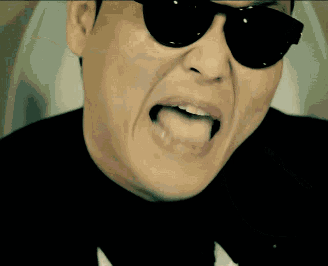 a man wearing sunglasses makes a funny face