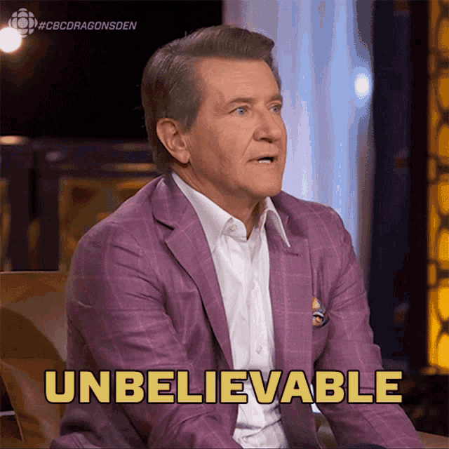 a man in a purple suit is sitting in a chair and says unbelievable