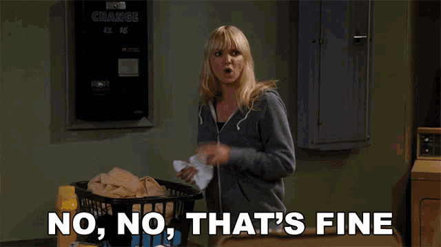 a woman in a laundromat with a basket of clothes and the words " no no that 's fine "