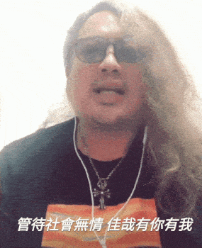 a man with long hair wearing sunglasses and a necklace with a cross on it