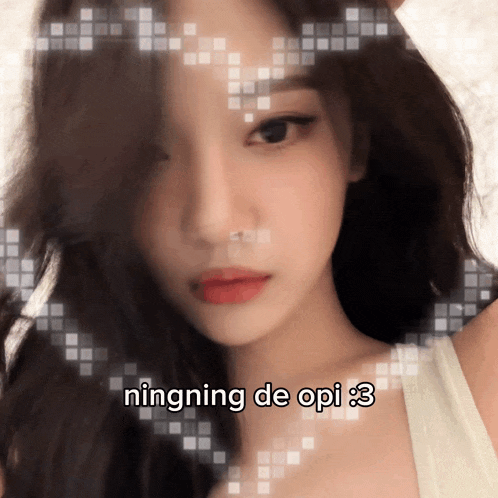 a close up of a woman 's face with the words ningning de opi 3 below her