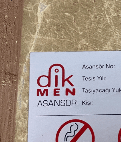 a sign on a wall that says dik men on it