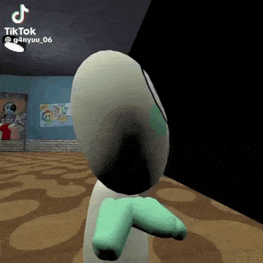 a cartoon character with green arms and legs is standing in a room with a brick wall in the background .