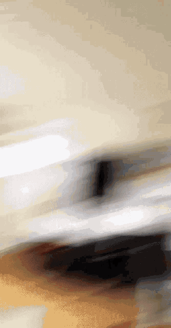 a blurred image of a person 's face with a gray background