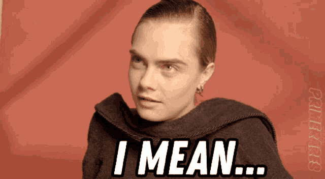 a woman says " i mean " in front of a red backdrop