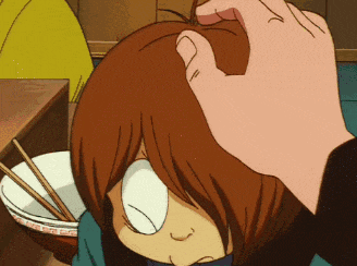 a person petting a cartoon character 's head with chopsticks in the background