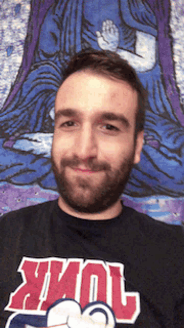 a man with a beard is wearing a black shirt that says york