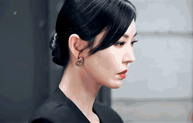 a close up of a woman 's face wearing earrings and a bun