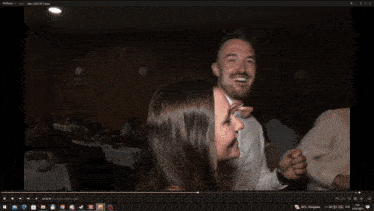 a computer screen shows a man in a bow tie dancing with other people