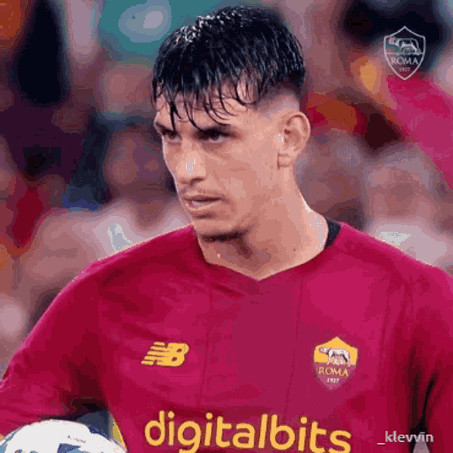a soccer player wearing a red jersey that says digitalbits on it