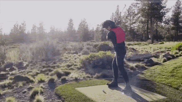 a man swinging a golf club on a golf course
