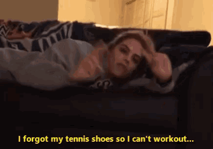 a woman laying on a couch with the words i forgot my tennis shoes so i can 't workout below her