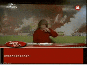 a woman in a red sweater is sitting at a red desk in front of a red sign that says avec ycia