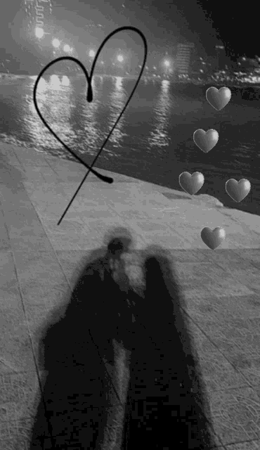 a black and white photo of a couple kissing with a heart drawn in the background