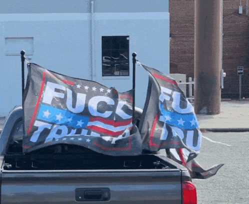 the back of a truck with a flag that says fuck trump