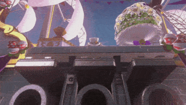 a video game scene with a ferris wheel and a cupcake with a hat on it