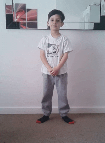 a young boy wearing a t-shirt that says america
