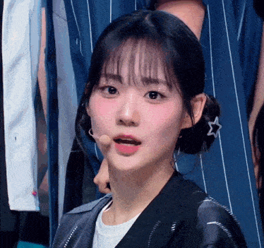 a close up of a girl with a star on her hair