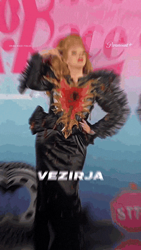 a woman in a black dress with the word vezirja written on the bottom