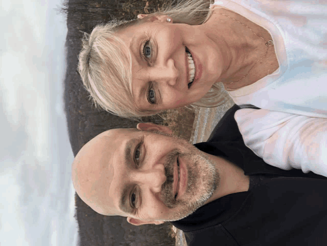 a man and a woman are smiling for a photo