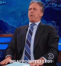 a man in a suit and tie is saying disappointeeeed
