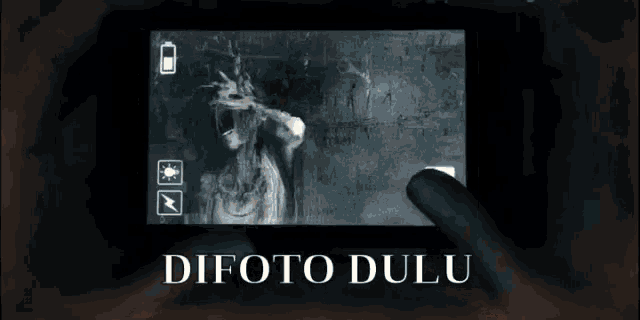 a phone screen shows a picture of a ghost and the words difoto dulu