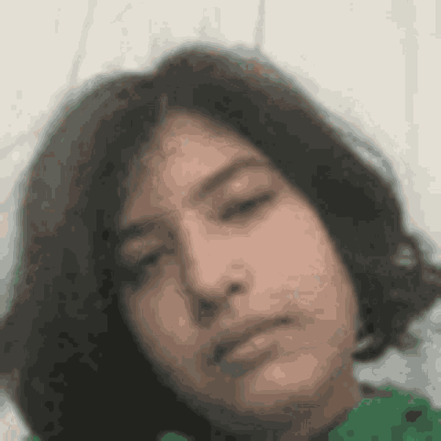 a close up of a young girl 's face with a serious look on her face .