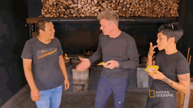 a group of people standing in front of a fireplace with the words national geographic on the bottom