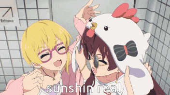 two anime girls are posing for a picture and one has a chicken hat on