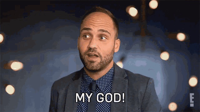 a man in a suit is saying my god